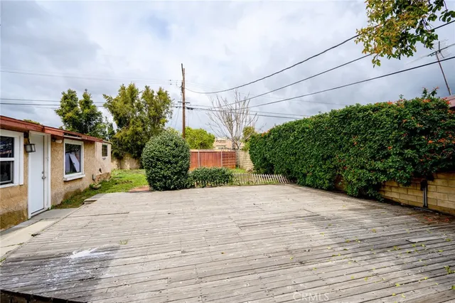 a front view of a house with a yard and potted plants