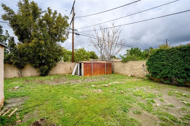 a view of a backyard with wooden fence