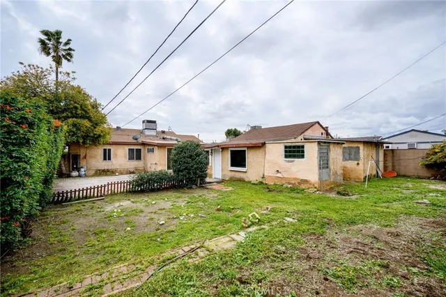 a view of a house with a yard and sitting area