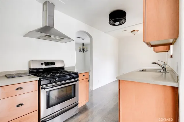 a kitchen with stainless steel appliances granite countertop a stove and a sink