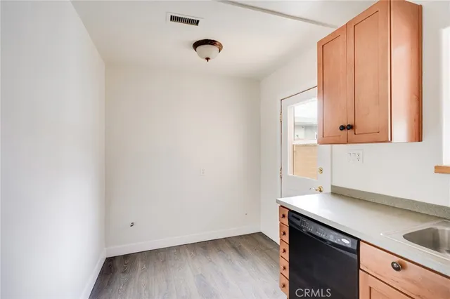 a view of an empty room and wooden floor