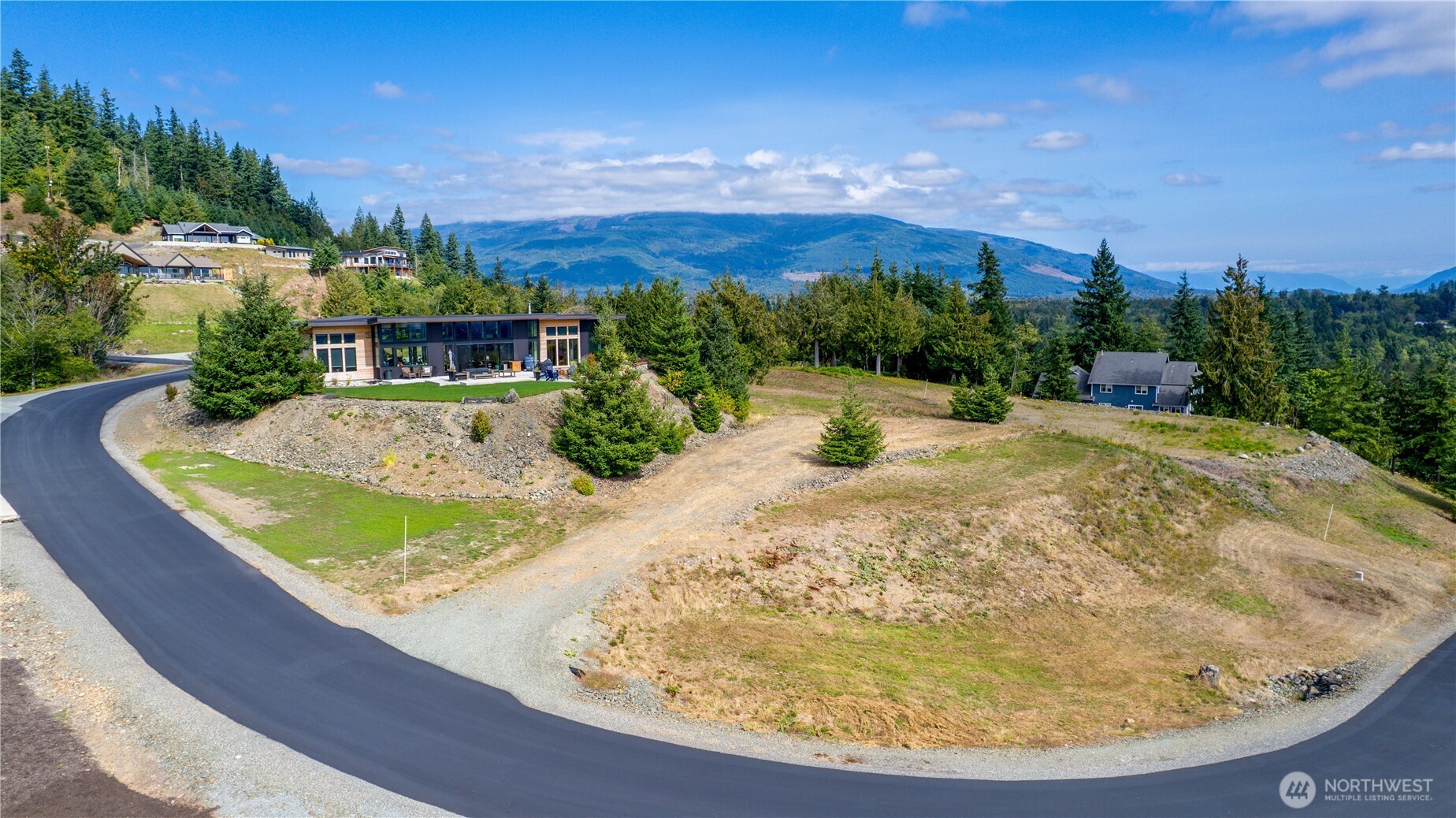 7583 Avalon Heights Way Sedro-Woolley, WA 98284 - Photo 2 of 28 a view of a swimming pool with a yard and plants