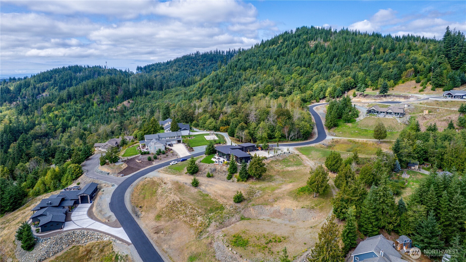 7583 Avalon Heights Way Sedro-Woolley, WA 98284 - Photo 22 of 28 a view of a swimming pool in he middle of the green field
