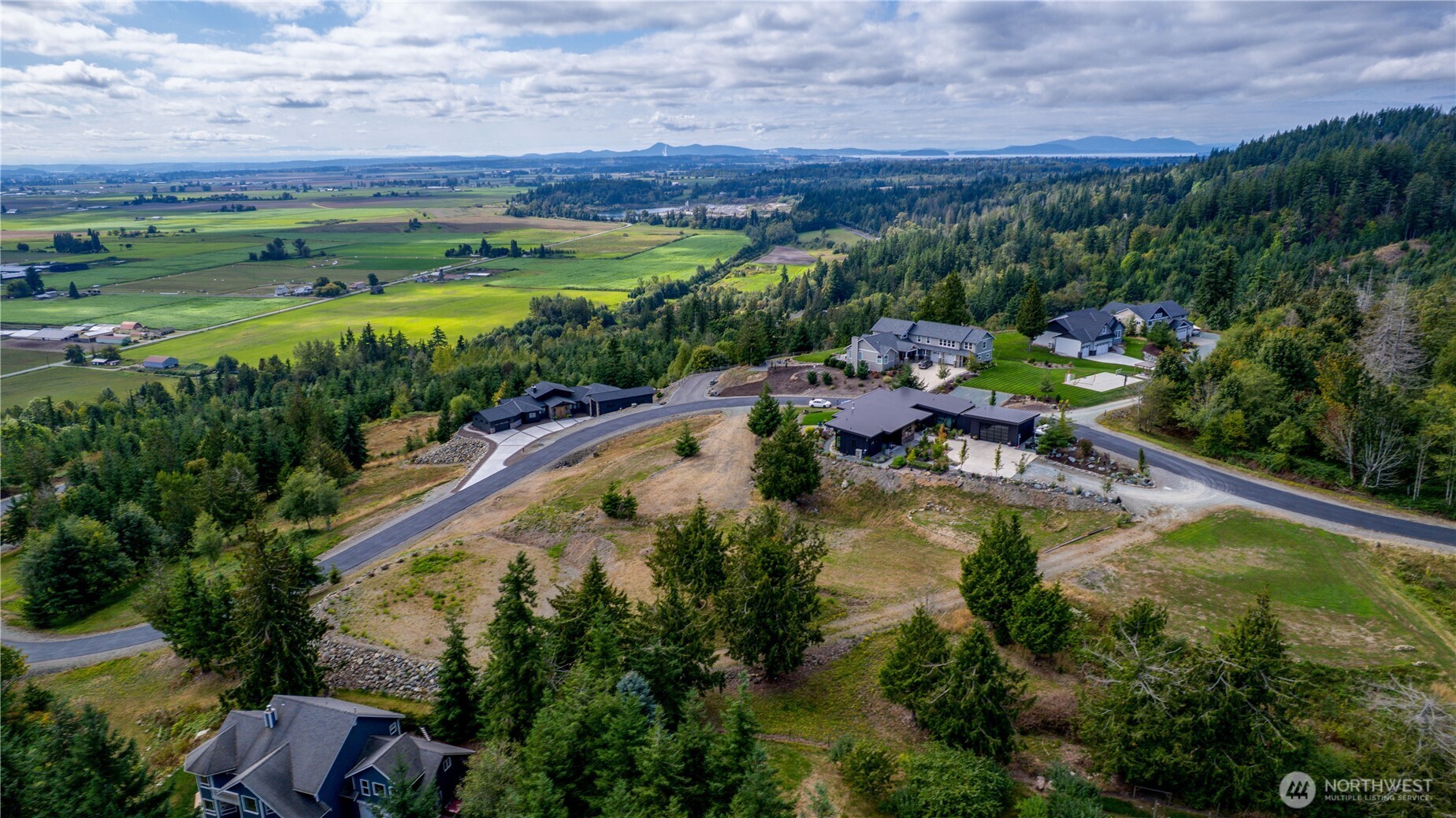 7583 Avalon Heights Way Sedro-Woolley, WA 98284 - Photo 24 of 28 an aerial view of a house with swimming pool and mountains