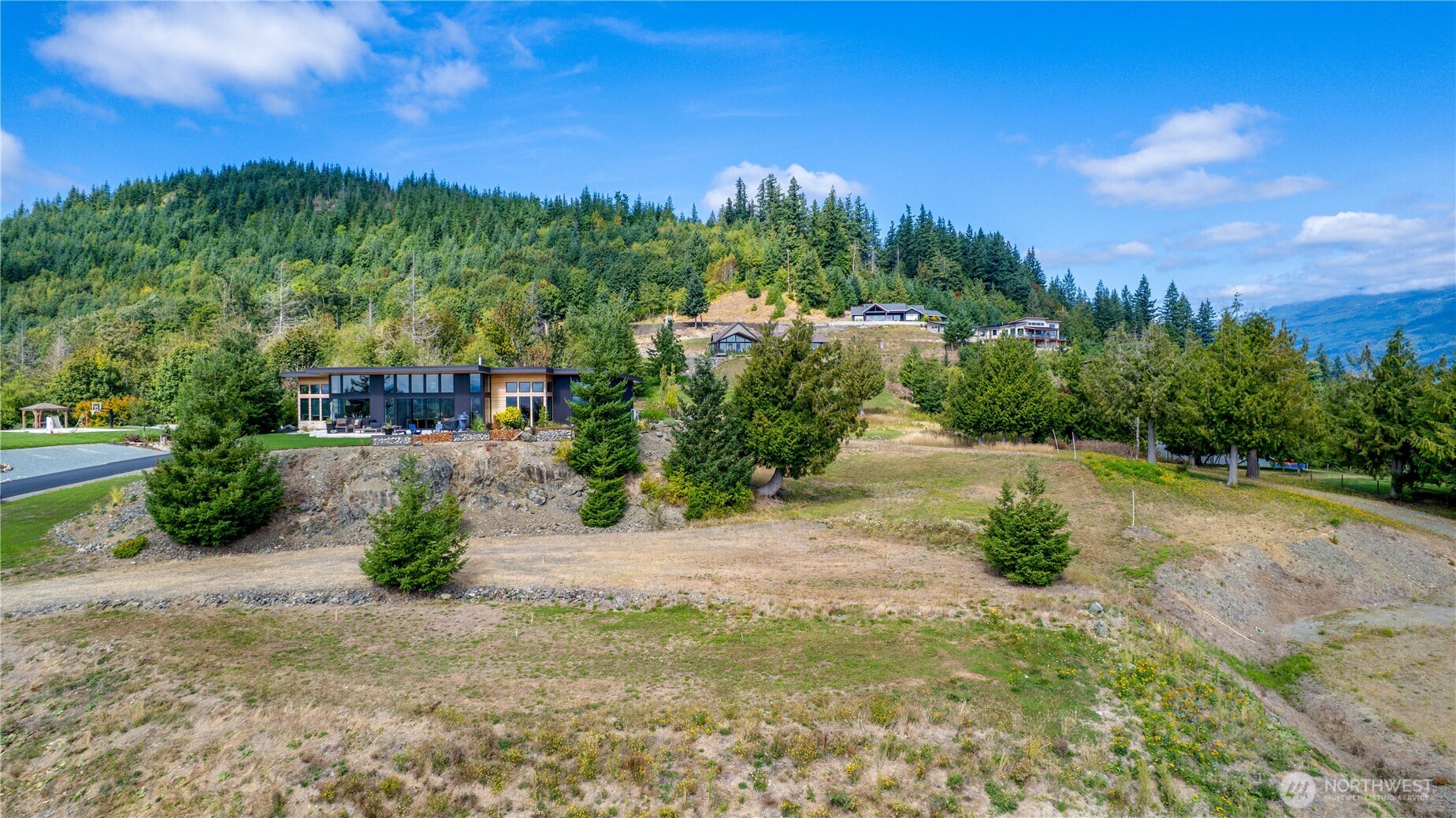 7583 Avalon Heights Way Sedro-Woolley, WA 98284 - Photo 8 of 28 a view of a garden with a building in the background