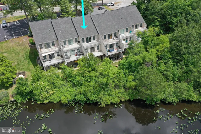 an aerial view of a house with a yard and lake view