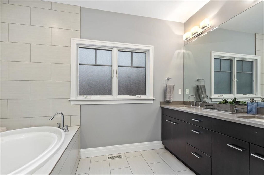 22 Raynor Drive, Unit 22 Hingham, MA 02043 - Photo 17 of 41 a bathroom with a granite countertop sink mirror and bathtub