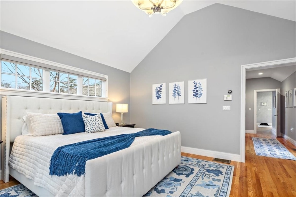22 Raynor Drive, Unit 22 Hingham, MA 02043 - Photo 18 of 41 a bedroom with a bed and wooden floor