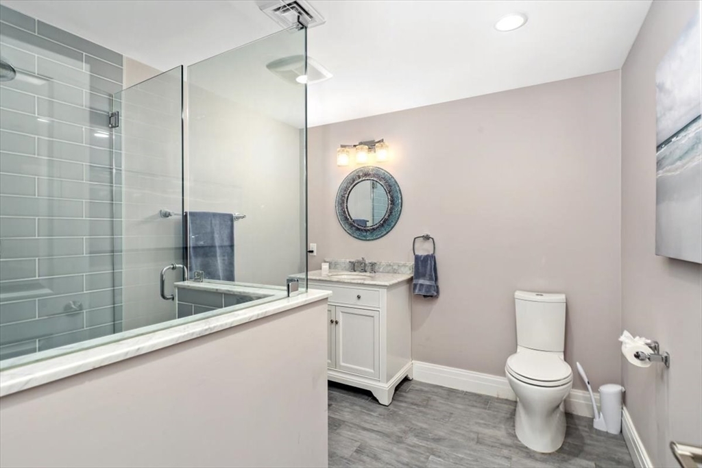 22 Raynor Drive, Unit 22 Hingham, MA 02043 - Photo 25 of 41 a bathroom with a toilet a sink and a mirror