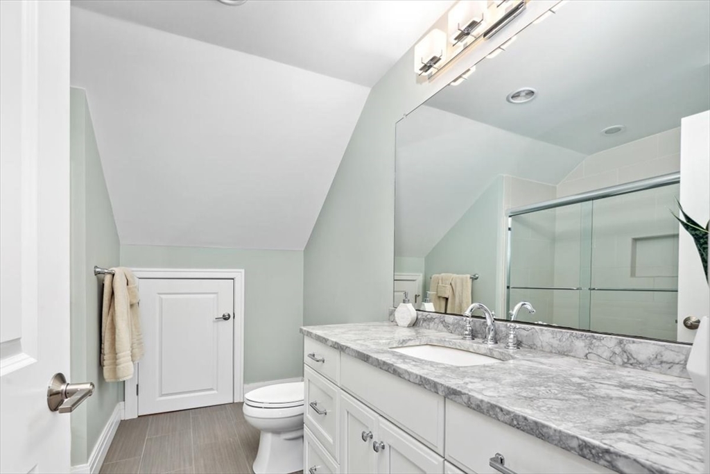 22 Raynor Drive, Unit 22 Hingham, MA 02043 - Photo 26 of 41 a bathroom with a granite countertop sink a toilet and a mirror