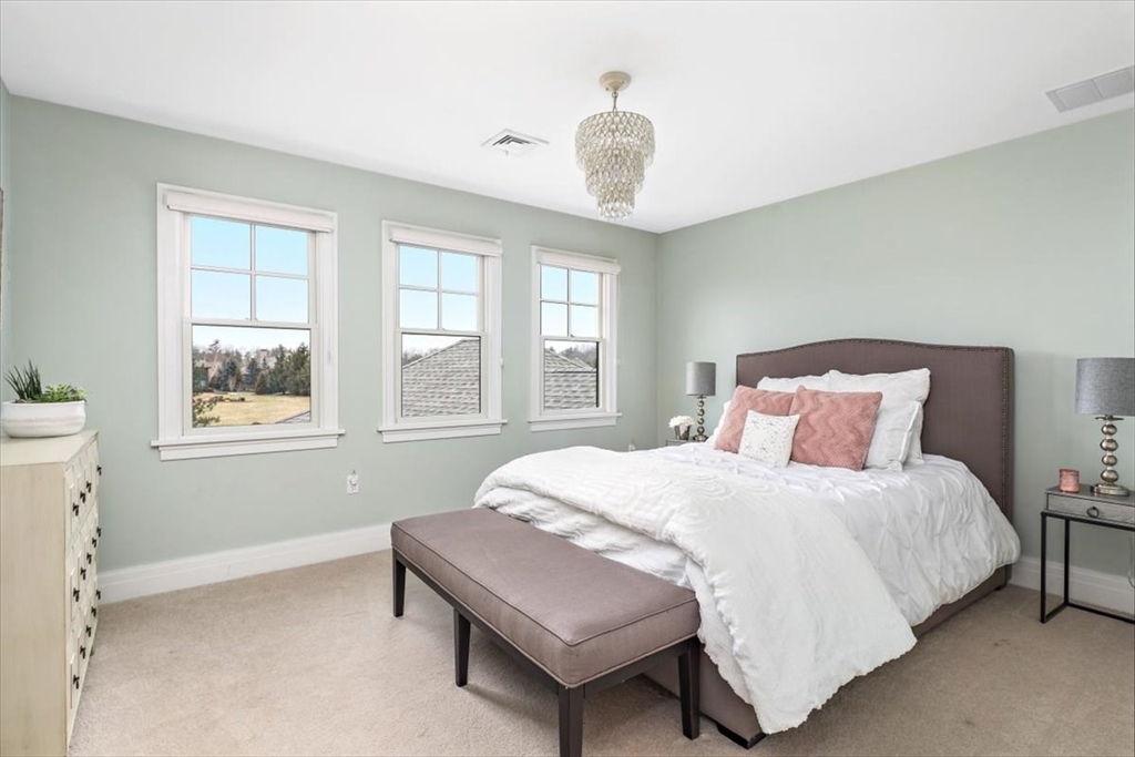 22 Raynor Drive, Unit 22 Hingham, MA 02043 - Photo 27 of 41 a bedroom with a bed and a window