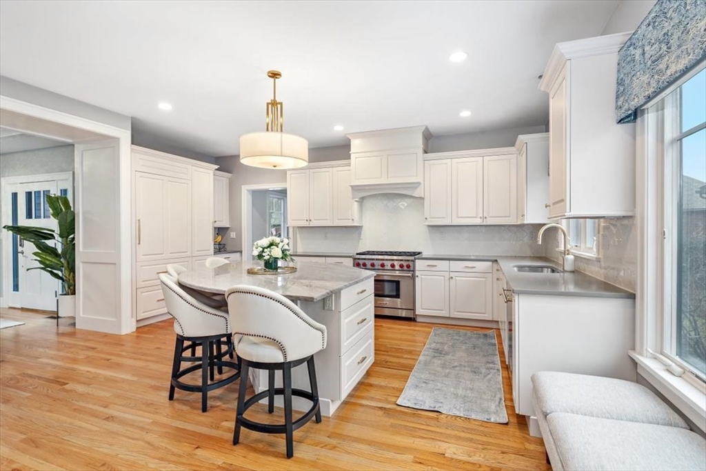 22 Raynor Drive, Unit 22 Hingham, MA 02043 - Photo 5 of 41 a kitchen with stainless steel appliances a dining table chairs stove refrigerator and cabinets