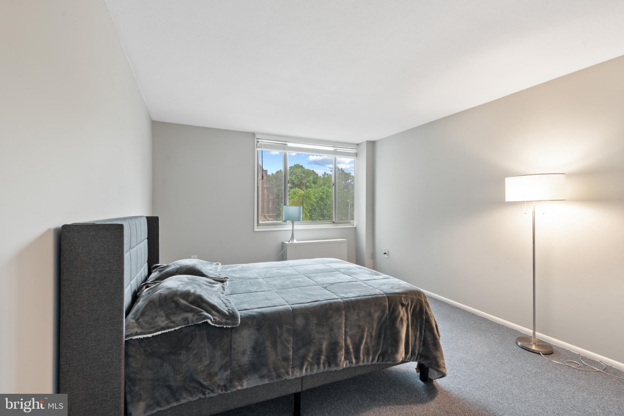 1 East University Parkway, Unit 304 Baltimore, MD 21218 - Photo 13 of 18 a bedroom with a bed and a window