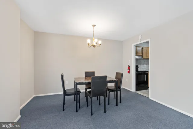 a view of a dining room with furniture and chandelier