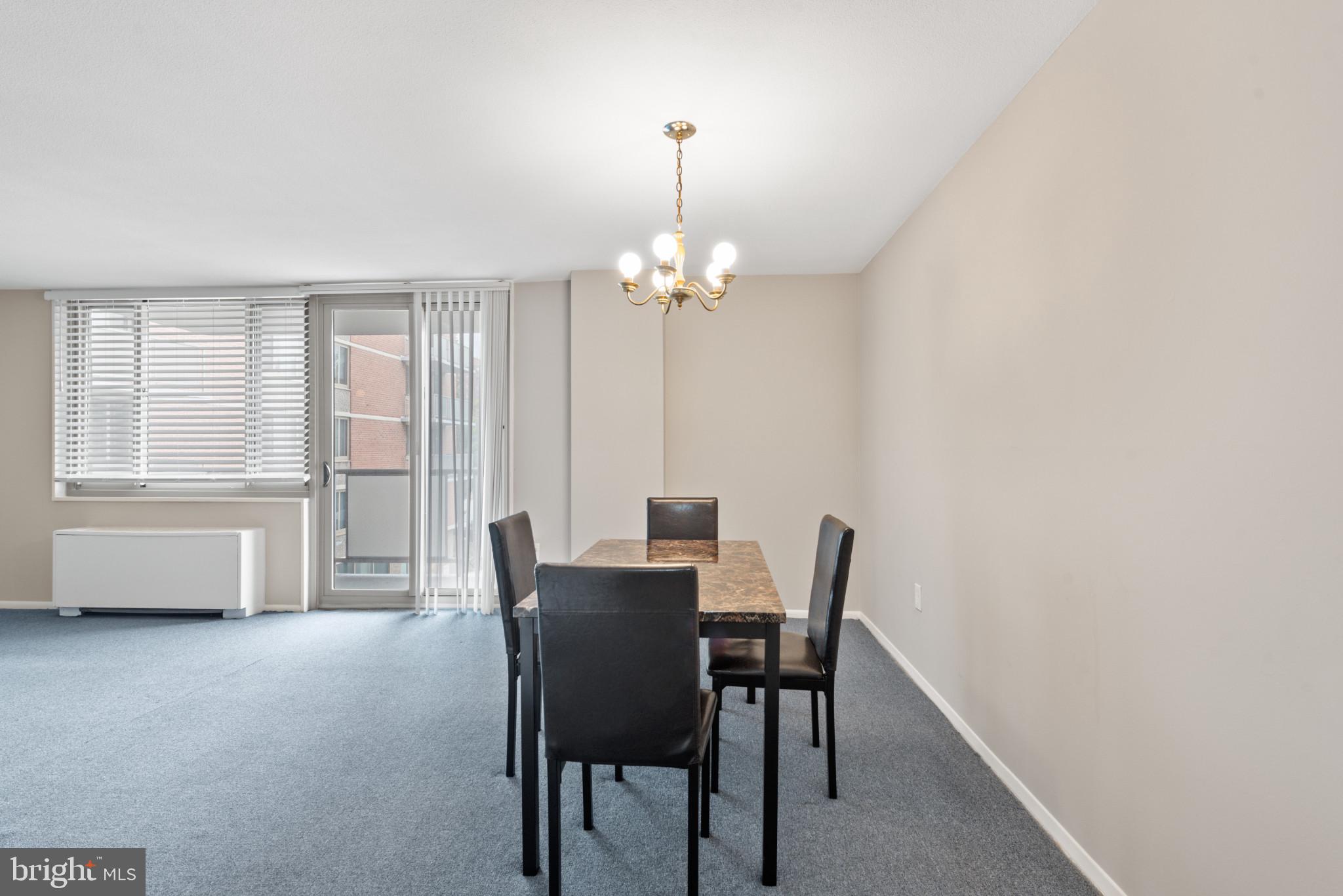1 East University Parkway, Unit 304 Baltimore, MD 21218 - Photo 8 of 18 a view of a dining room with furniture and chandelier