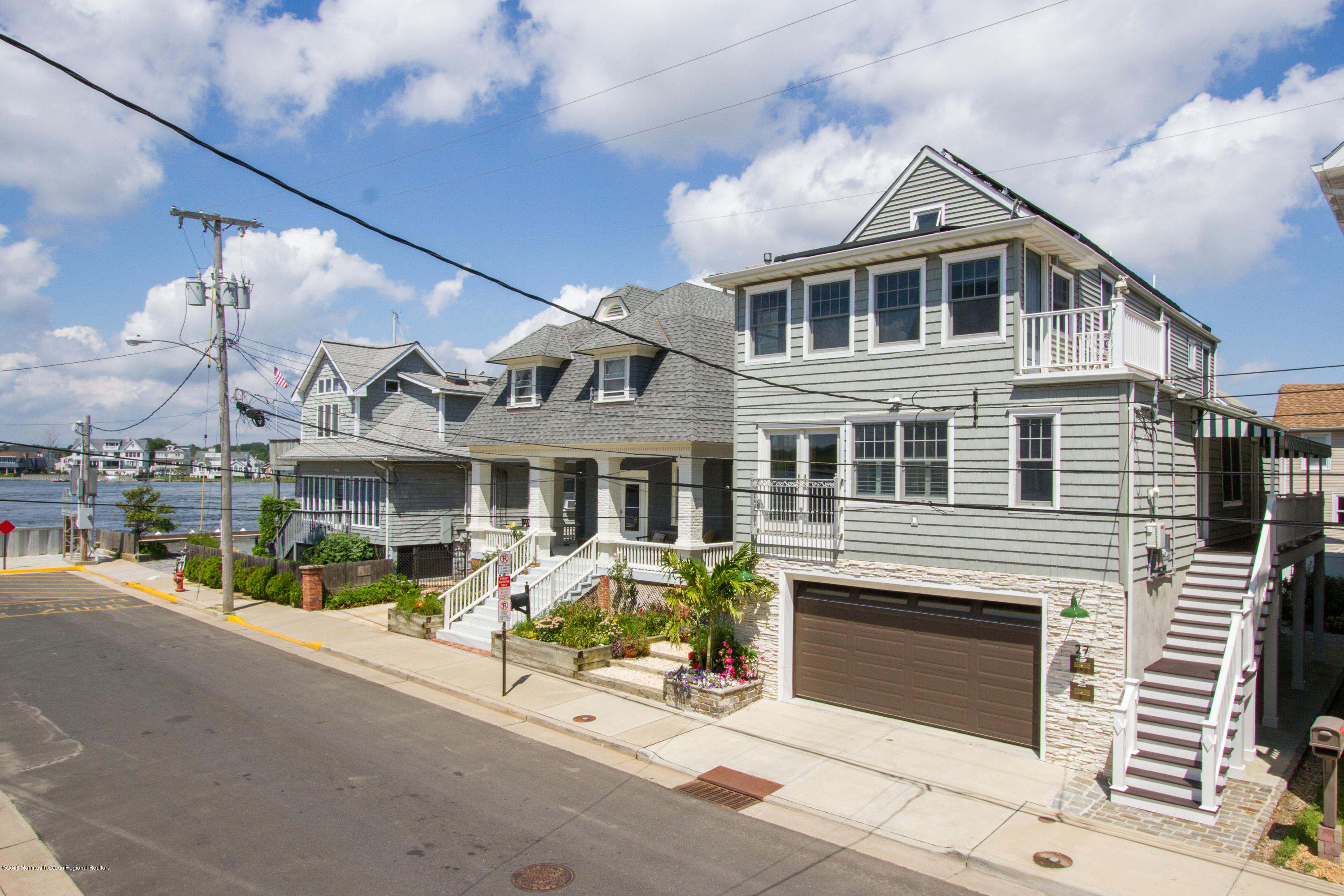 a front view of a house with a yard fire pit and outdoor seating