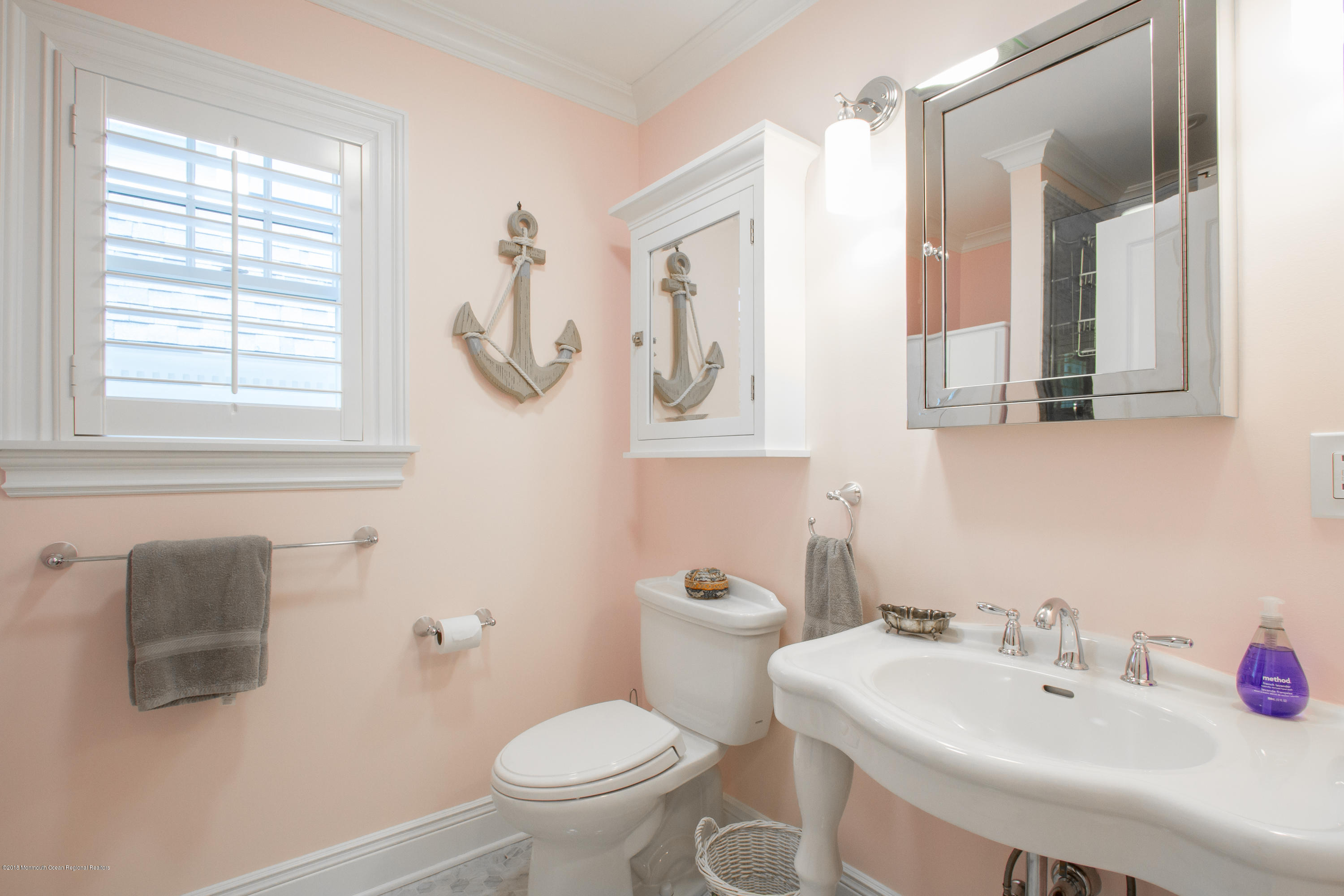 27 Center Street Sea Bright, NJ 07760 - Photo 17 of 51 a bathroom with a sink mirror and toilet