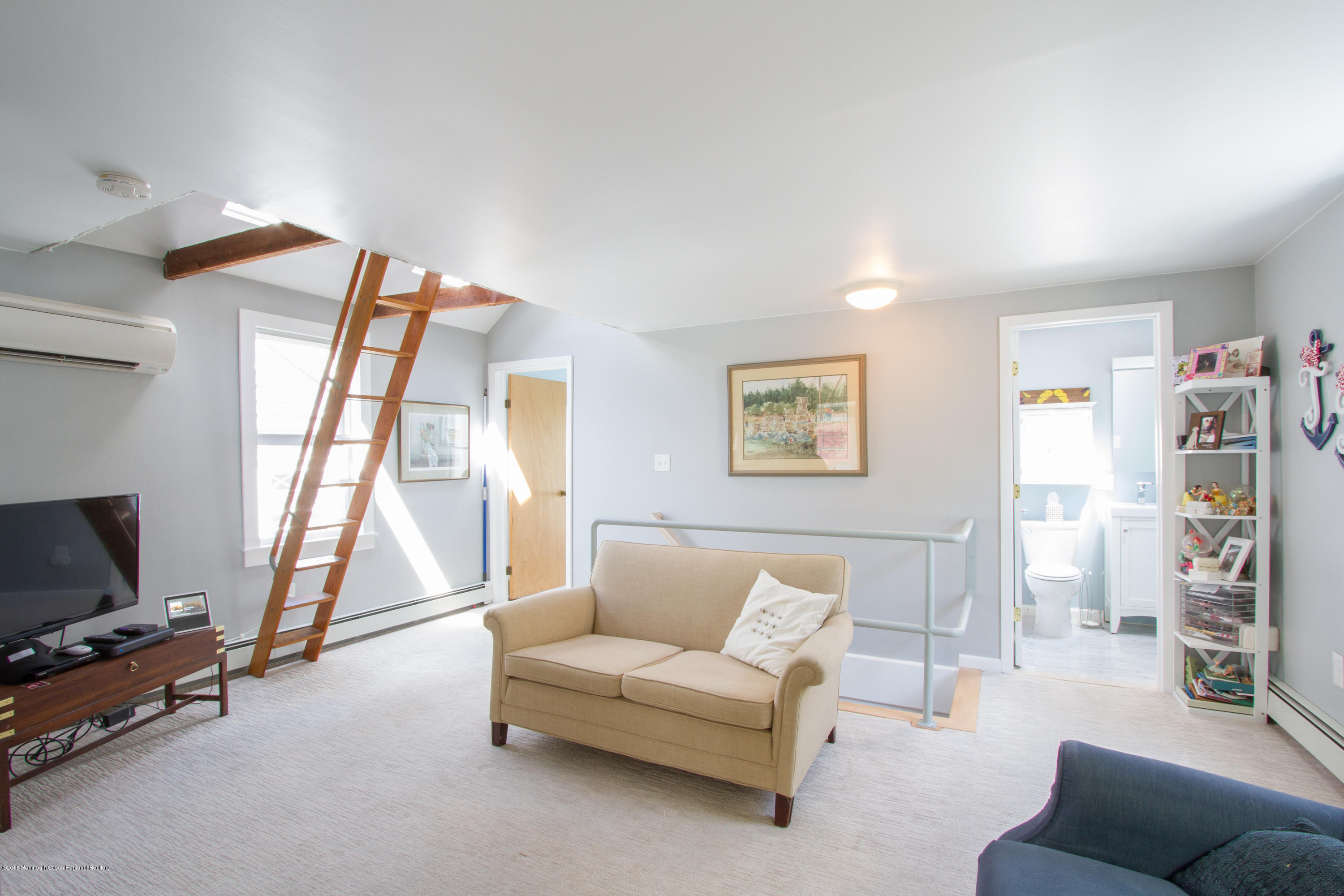 27 Center Street Sea Bright, NJ 07760 - Photo 28 of 51 a living room with furniture a flat screen tv and a window