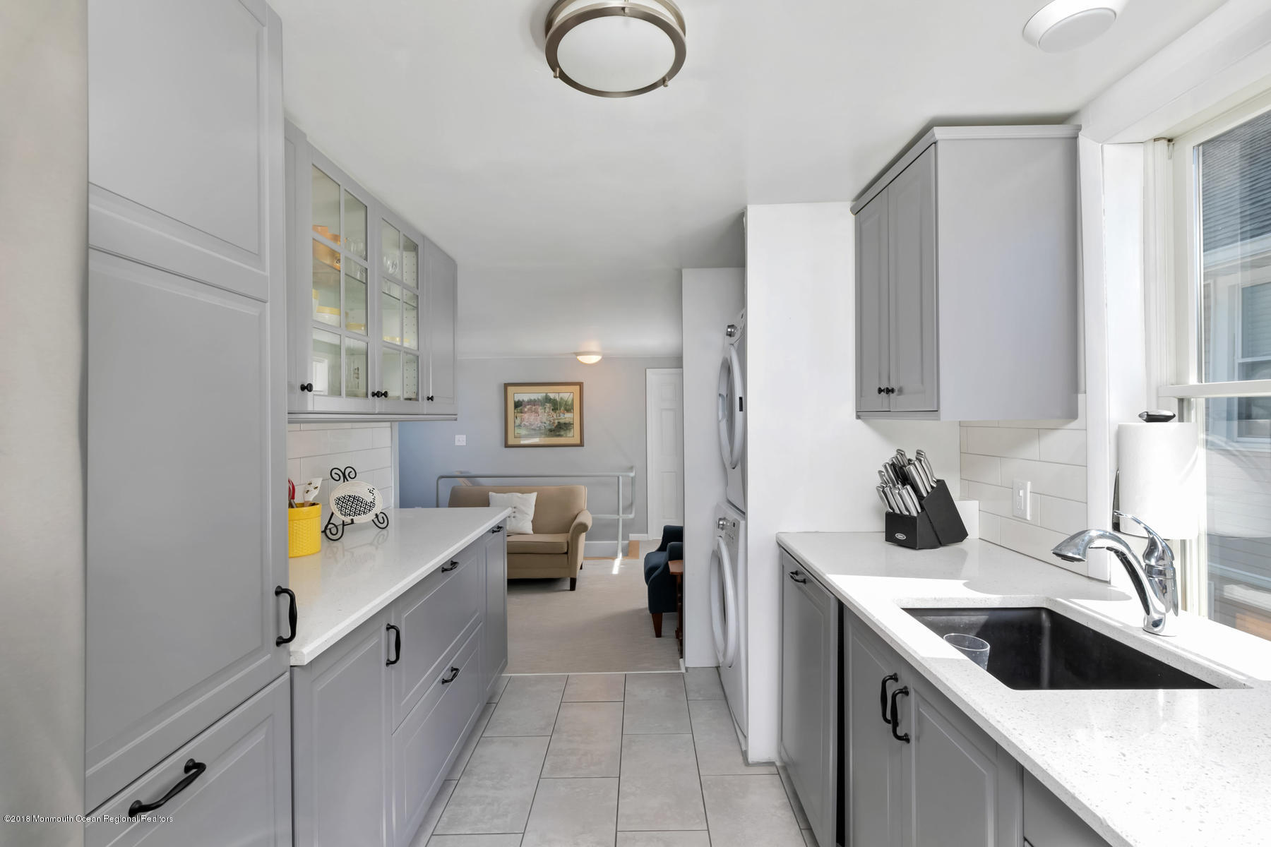 27 Center Street Sea Bright, NJ 07760 - Photo 30 of 51 a kitchen with a sink stove and cabinets