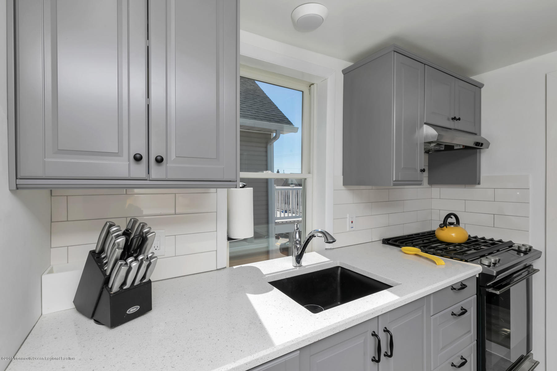 27 Center Street Sea Bright, NJ 07760 - Photo 31 of 51 a kitchen with a sink and cabinets