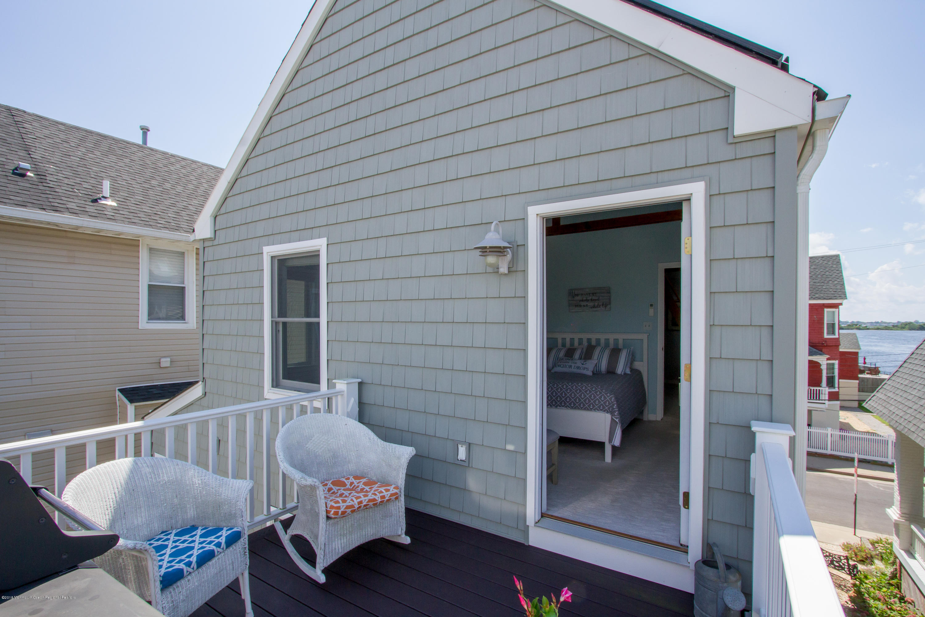 27 Center Street Sea Bright, NJ 07760 - Photo 35 of 51 a balcony with furniture and a potted plant