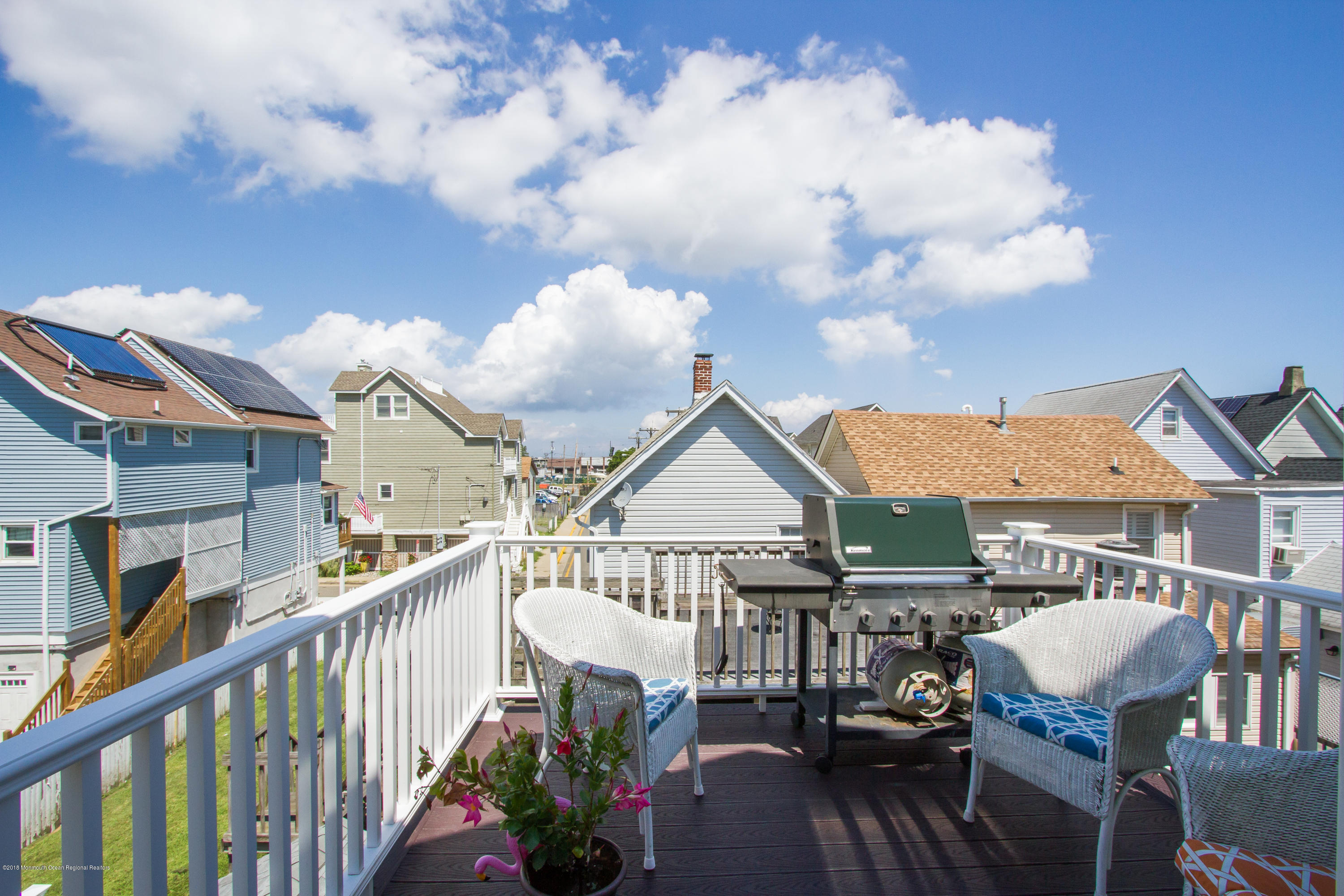 27 Center Street Sea Bright, NJ 07760 - Photo 36 of 51 a view of a house with wooden deck and furniture