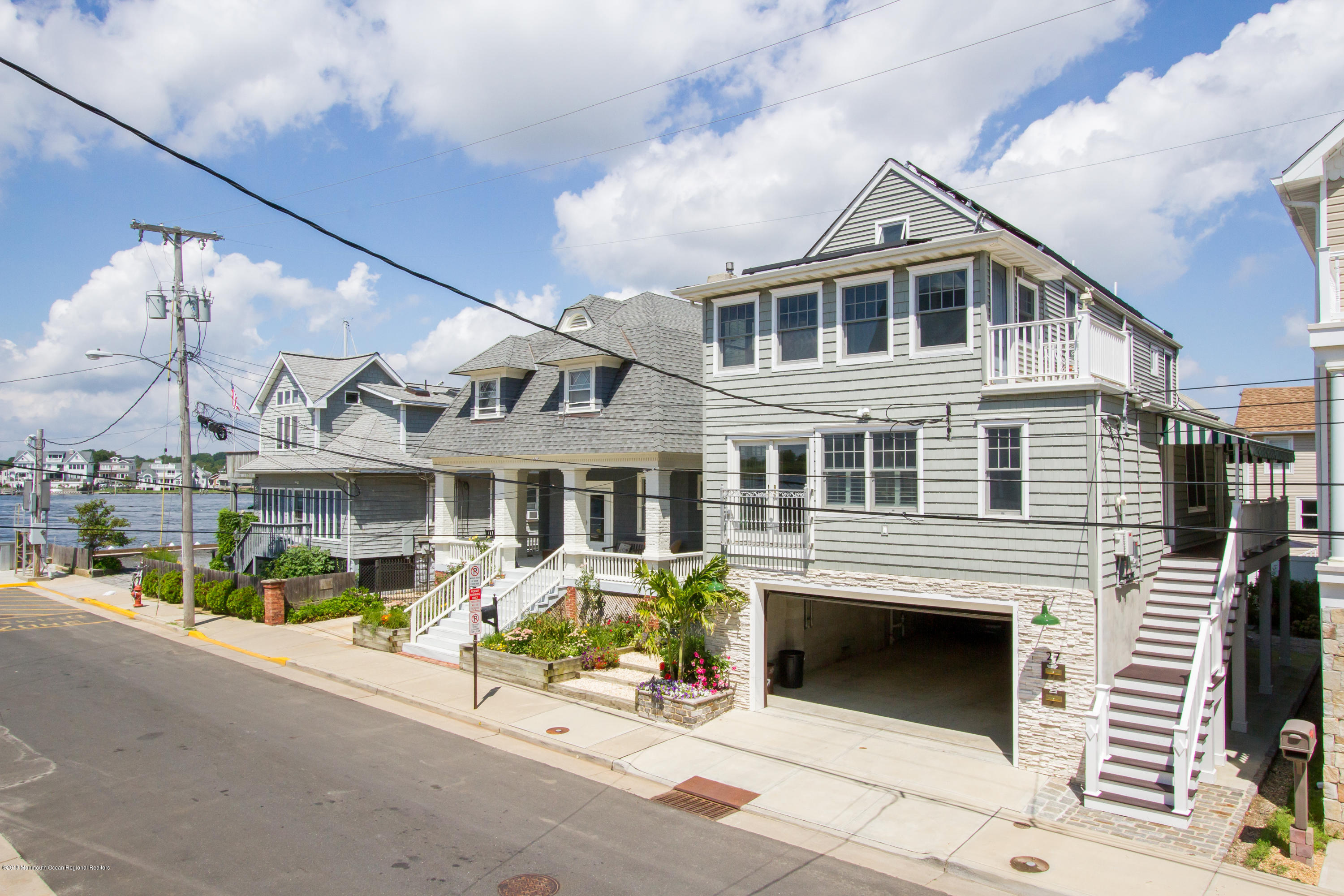 27 Center Street Sea Bright, NJ 07760 - Photo 38 of 51 a front view of a building with a garden and mountain view