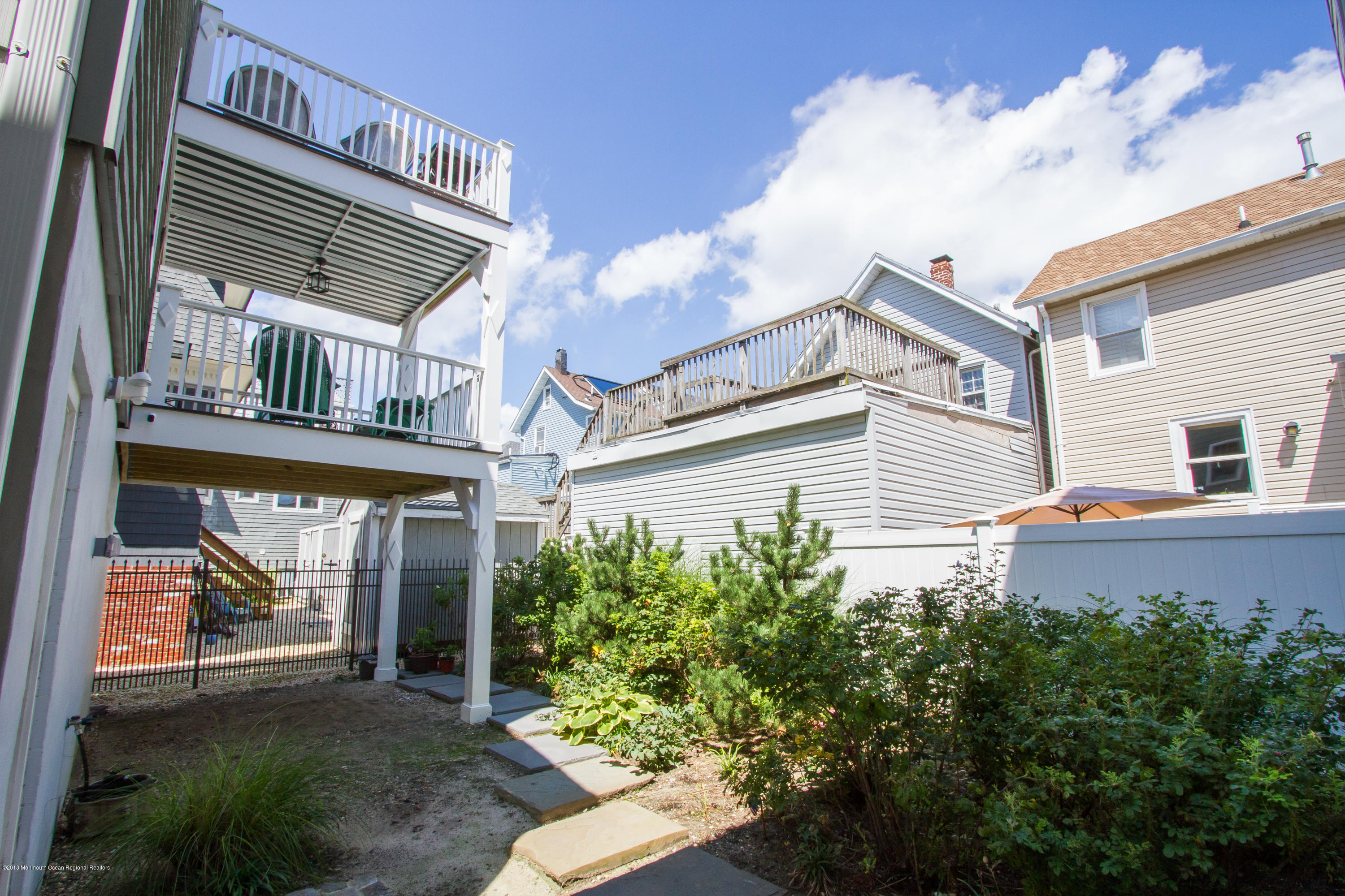 27 Center Street Sea Bright, NJ 07760 - Photo 39 of 51 a view of a white house next to a yard