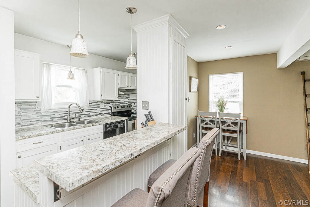 2713 South Ridge Drive Midlothian, VA 23112 - Photo 7 of 49 a kitchen with stainless steel appliances granite countertop a stove top oven a sink a dining table and chairs