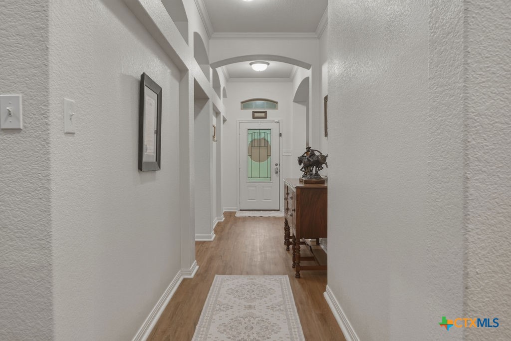 3306 Spring Canyon Road Belton, TX 76513 - Photo 9 of 40 a view of a hallway with wooden floor and staircase
