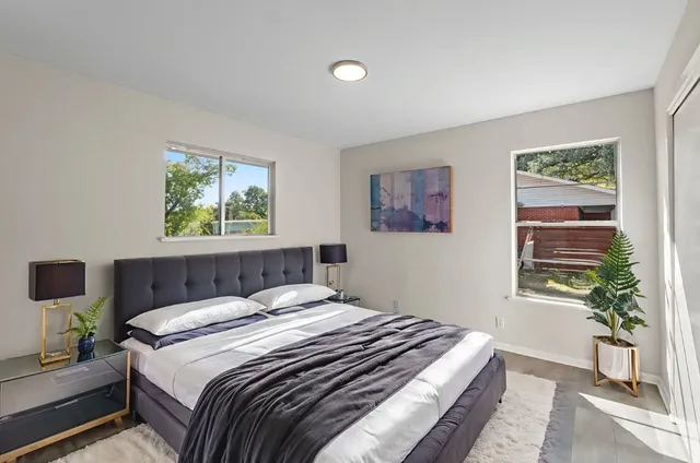 a bedroom with a bed and a painting on the wall