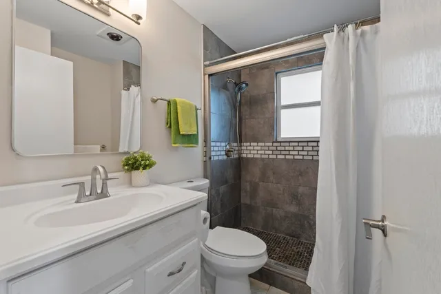 a bathroom with a sink toilet and shower