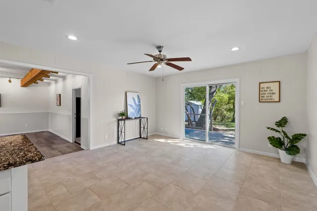 a view of a livingroom with a ceiling fan and window