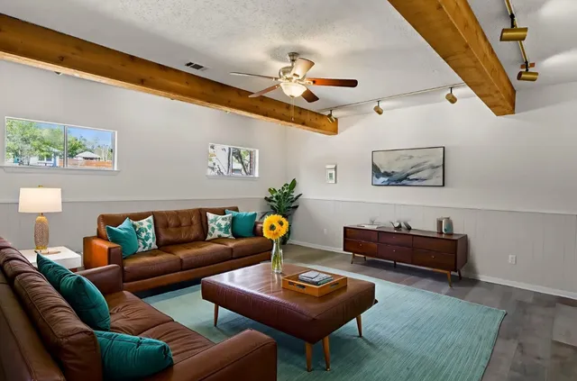 a living room with furniture a rug and a chandelier