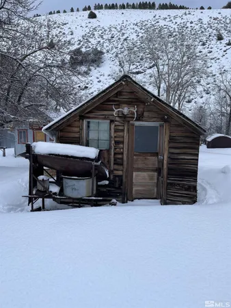 a backyard of a house with table and chairs