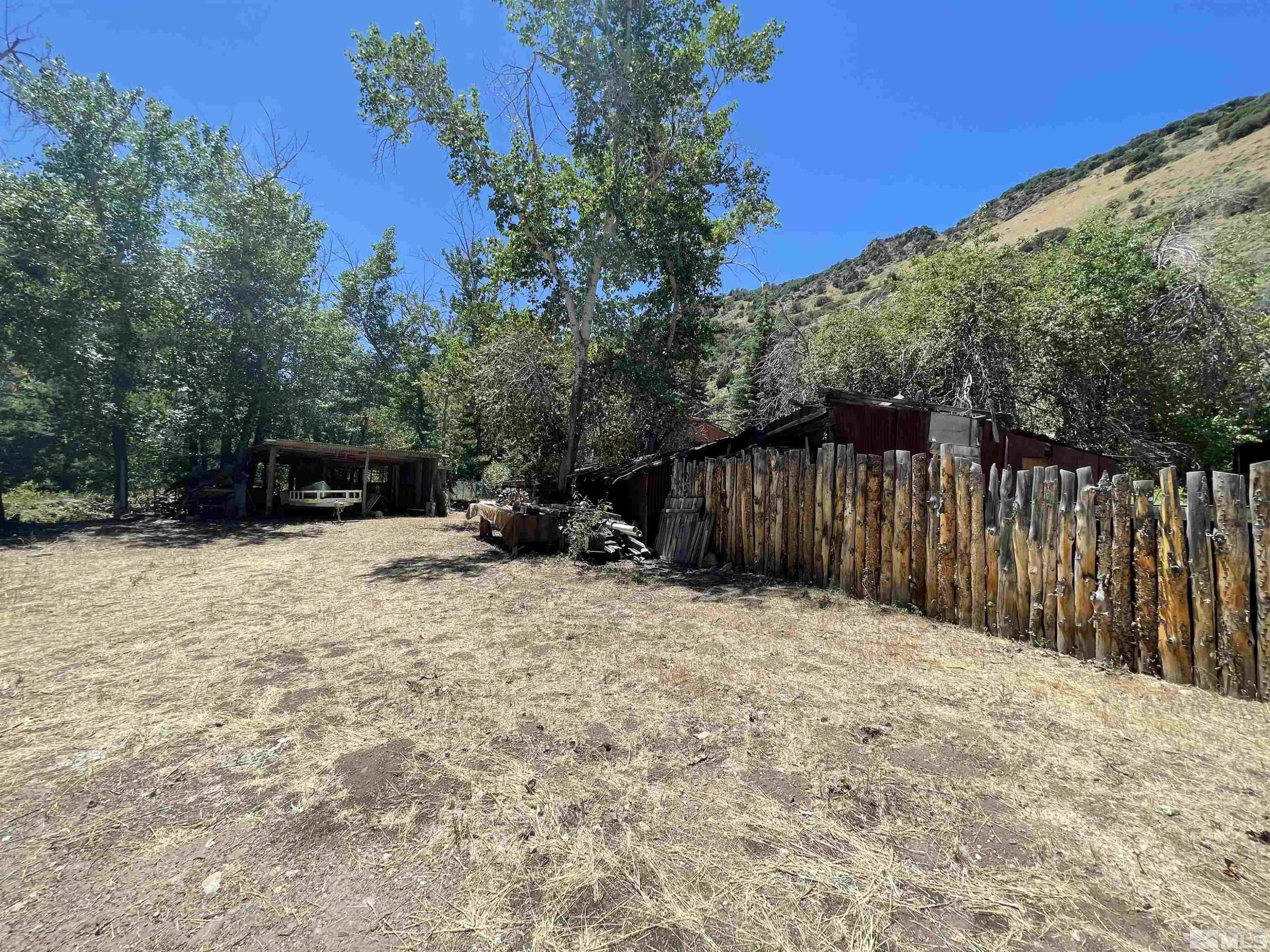 202 Main Street Jarbidge, NV 89826 - Photo 14 of 20 a backyard of a house with table and chairs