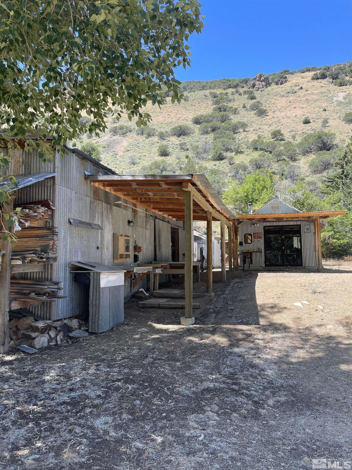 202 Main Street Jarbidge, NV 89826 - Photo 9 of 20 a view of a house with a yard and sitting area