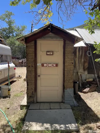 a view of a wooden door in front of house