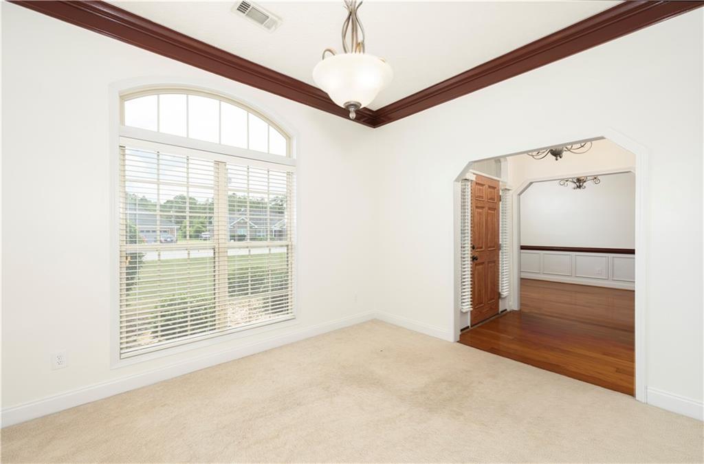 8 Ridgebrook Drive Phenix City, AL 36869 - Photo 6 of 21 Carpeted empty room with crown molding and arched walkways