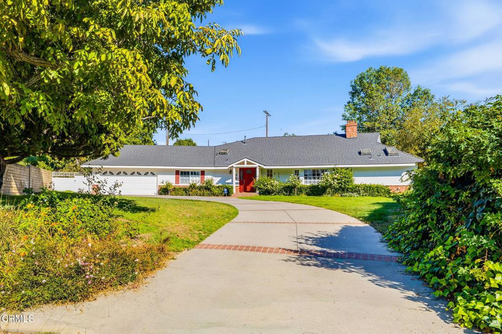 a view of house with garden and entertaining space