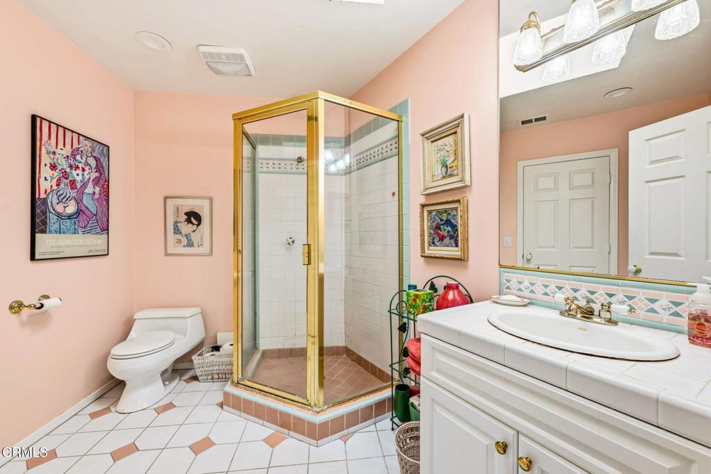 17933 Osborne Street Northridge, CA 91325 - Photo 17 of 33 a bathroom with a sink toilet and a mirror