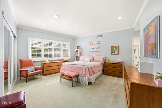 a spacious bedroom with a bed and a desk