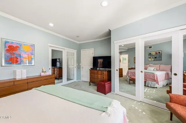 a bedroom with furniture and a flat screen tv