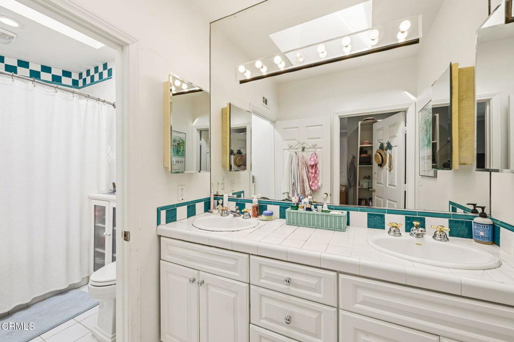 17933 Osborne Street Northridge, CA 91325 - Photo 21 of 33 a bathroom with a sink double vanity and a mirror