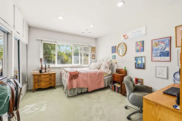 a living room with furniture and large windows