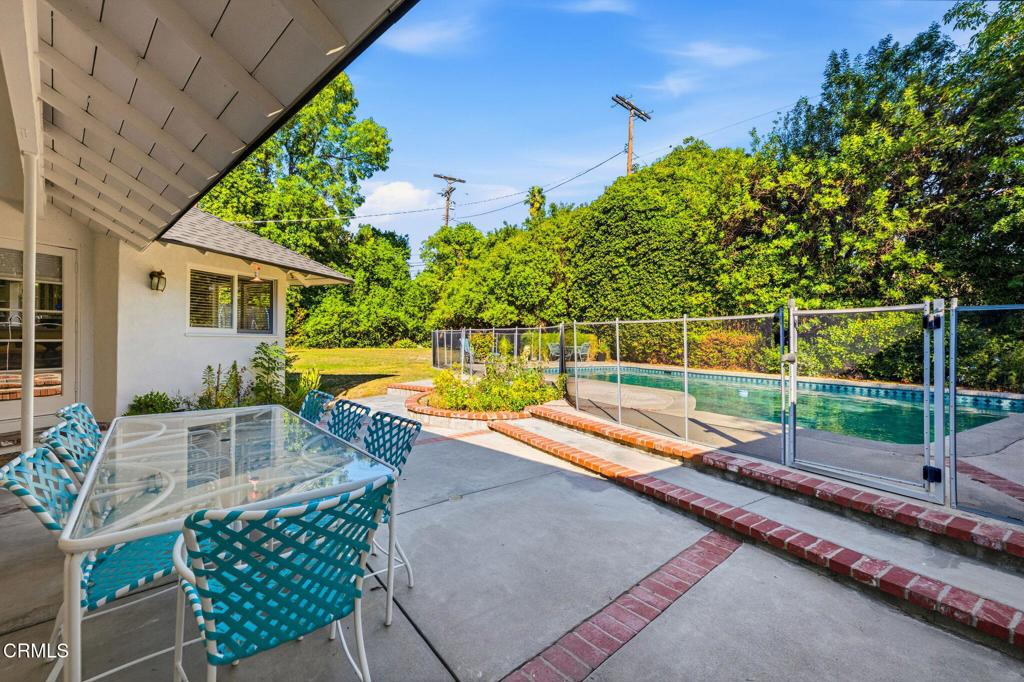 17933 Osborne Street Northridge, CA 91325 - Photo 28 of 33 a view of a chairs and table in the backyard