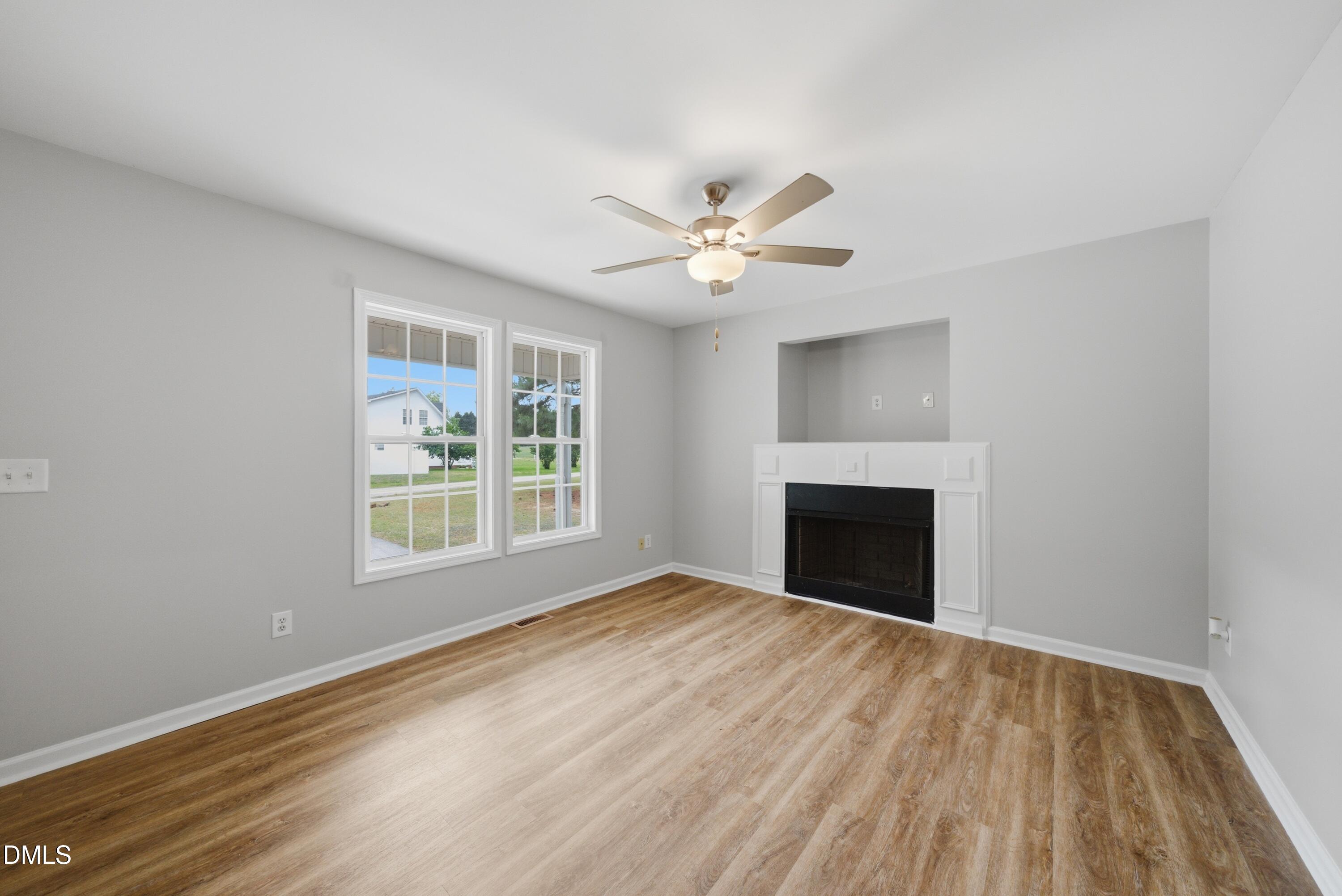 201 Tonylee Court, Unit A Raleigh, NC 27603 - Photo 9 of 30 a view of an empty room with a window and a fireplace