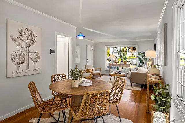 a view of a dining room with furniture and wooden floor