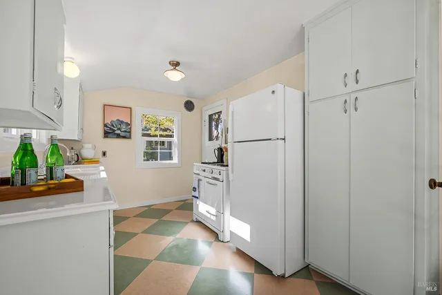 a kitchen with stainless steel appliances a refrigerator and a stove