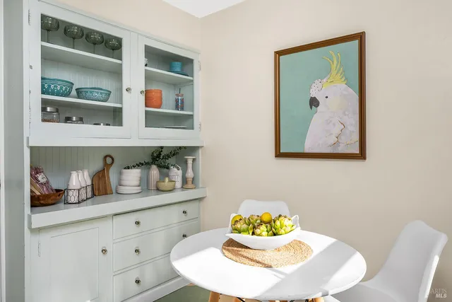 a dining room with furniture and wooden floor